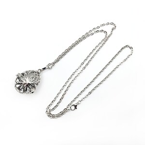 May include: A silver chain necklace with a silver pendant shaped like a teardrop with an intricate design. The pendant is hollow and has a small opening at the top.