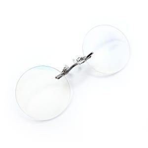 May include: A pair of silver-toned, round, rimless reading glasses with a spring hinge.