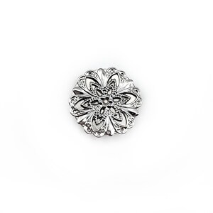 May include: Silver filigree flower brooch with a delicate, intricate design.