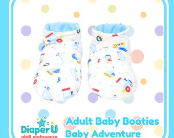 May include: A pair of white baby booties with a blue interior and a colorful pattern of vehicles. The booties have a rolled cuff and are decorated with red, blue, and yellow illustrations. The text "Adult Baby Booties Baby Adventure" is also visible.