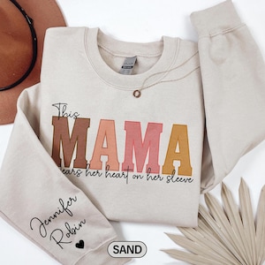 Custom This Mama Wears Her Heart On Her Sleeve Sweatshirt, Personalized Mom Sweatshirt With Kids Names, Cute Momma Outfit, Mothers Day Gifts