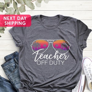 May include: Gray t-shirt with a graphic of sunglasses with palm trees reflected in the lenses. The text "Teacher Off Duty" is below the sunglasses.