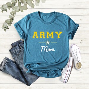 May include: A teal blue t-shirt with the words "ARMY Mom" in yellow and white lettering. A white star is between the words "ARMY" and "Mom".