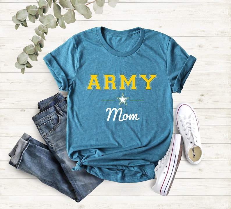 May include: A teal blue t-shirt with the words "ARMY Mom" in yellow and white lettering. A white star is between the words "ARMY" and "Mom".