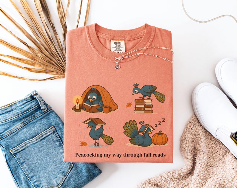 Comfort Colors shirt with whimsical peacock illustrations reading books, paired with pumpkins and cozy fall designs, perfect book lover tee.
Book Lover Comfort Colors Tee.nautumn gift for bookworms, librarians, teachers, and peacock lovers.
peacock shirt, funny peacock tee, peacock lover gift, book lover shirt, fall reading shirt, comfort colors tee, bookish shirt, librarian gift, cute peacock shirt, autumn book shirt, teacher gift tee, book club shirt, cozy fall shirt