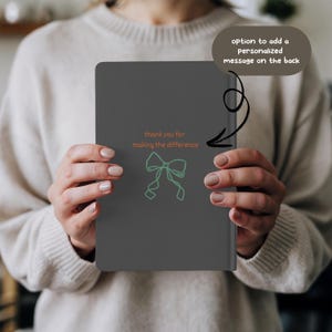 “Personalized Occupational Therapist Journal featuring orange and green design with medical icons, stethoscope, and bow illustration. Custom hardcover notebook gift for OT students, occupational therapists, and therapy professionals.”