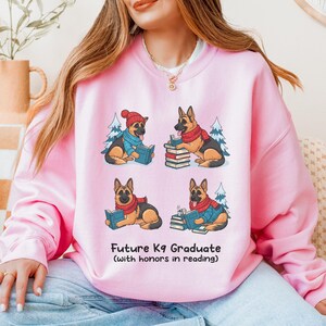 Future K9 Graduate Sweatshirt. This cozy German Shepherd shirt features four cute German Shepherds reading books, making it a perfect dog lover gift. It's an ideal bookish jumper and a great Xmas gift for dog moms and dog dads who love reading. This holiday sweatshirt is a funny and charming way to celebrate a love for dogs and books during the winter holiday season.