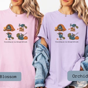 Comfort Colors shirt with whimsical peacock illustrations reading books, paired with pumpkins and cozy fall designs, perfect book lover tee.
Book Lover Comfort Colors Tee.nautumn gift for bookworms, librarians, teachers, and peacock lovers.
peacock shirt, funny peacock tee, peacock lover gift, book lover shirt, fall reading shirt, comfort colors tee, bookish shirt, librarian gift, cute peacock shirt, autumn book shirt, teacher gift tee, book club shirt, cozy fall shirt