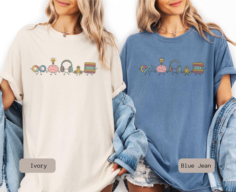 Comfort Colors Autism Doodle Characters Shirt featuring colorful, hand-drawn inclusive characters. Neatly styled next to classroom supplies, making it an ideal inclusion shirt, autism teacher shirt, and back to school shirt.