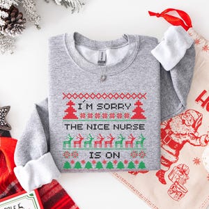A Funny Nurse Gift sweatshirt, designed like an Ugly Xmas Sweater, with the sarcastic phrase "I'm Sorry The Nice Nurse Is On Vacation." This is ideal for an RN LPN Nurse or ICU Nurse Gif