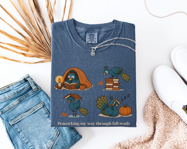Comfort Colors shirt with whimsical peacock illustrations reading books, paired with pumpkins and cozy fall designs, perfect book lover tee.
Book Lover Comfort Colors Tee.nautumn gift for bookworms, librarians, teachers, and peacock lovers.
peacock shirt, funny peacock tee, peacock lover gift, book lover shirt, fall reading shirt, comfort colors tee, bookish shirt, librarian gift, cute peacock shirt, autumn book shirt, teacher gift tee, book club shirt, cozy fall shirt