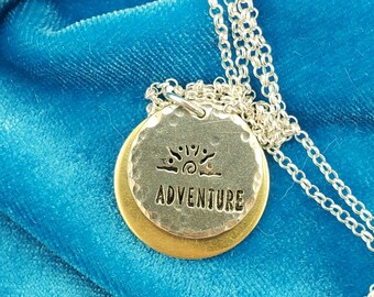 A Rising Nirvana Sun with the word "ADVENTURE" on a Mixed Metal Necklace