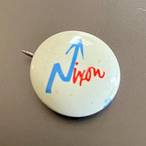 Small Richard Nixon campaign pin with arrow up