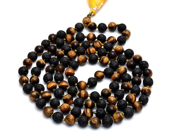 May include: A mala or prayer beads made with tiger's eye and black lava rock beads. The mala has a tassel made of orange thread.