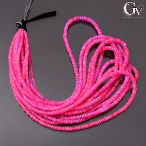 May include: A strand of pink opal beads, approximately 4mm in diameter, strung on a black cord. The beads are a vibrant pink colour with a slight iridescent sheen.