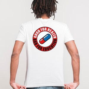 May include: White t-shirt with a red circle graphic on the back. The graphic features a red and blue pill with the text "Good for Health Bad for Education".