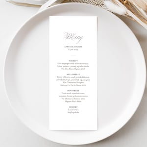 May include: A wedding menu card with a calligraphic font for the word "Menu" at the top. The menu lists the courses for the wedding reception: "Forrett", "Mellomrett", "Hovrett", and "Dessert".