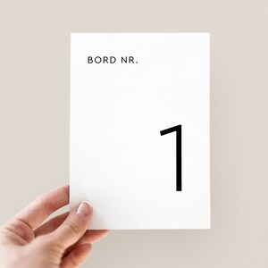 May include: White card with black text that reads "BORD NR." and the number "1" printed on it.