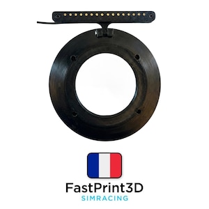 May include: A black circular device with a large central opening, featuring a top bar with small gold-coloured lights. The device has a textured surface and is mounted on a white background. The text "FastPrint3D SIMRACING" is displayed below the device.