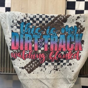 May include: Gray fleece blanket with a dirt track design and the text "This is my dirt track watching blanket".