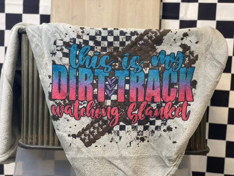 May include: Gray fleece blanket with a dirt track design and the text "This is my dirt track watching blanket".