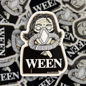 May include: A die-cut sticker featuring a black and white illustration of a person with dark hair wearing a breathing apparatus over their face. The person wears a black shirt with the word WEEN printed in large white capital letters below.