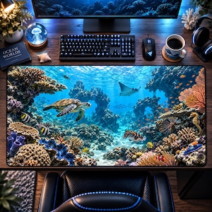 May include: A rectangular desk mat featuring a vibrant underwater coral reef scene. The design displays a sea turtle, a stingray, a seahorse, and various tropical fish swimming among colorful coral formations, sponges, and rocky structures.