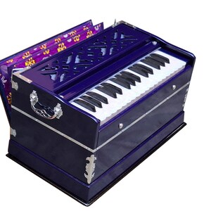 May include: A blue wooden harmonium with a white keyboard and a floral patterned lid. The harmonium has silver accents and a decorative design on the front.