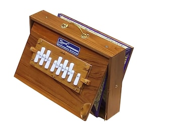 May include: A wooden harmonium with a brown finish and a purple fabric lining. The harmonium has a set of white keys and a brass handle.