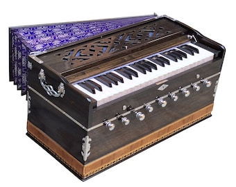 May include: A dark brown wooden harmonium with a purple bellows, a keyboard, and silver knobs. The harmonium is a traditional Indian musical instrument.