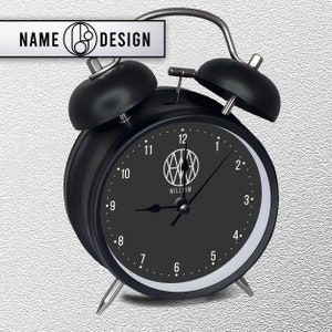 black metal alarm clock with name logo