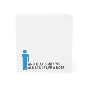 May include: White cube-shaped notepad with a blue stick figure and the text "AND THAT'S WHY YOU ALWAYS LEAVE A NOTE".