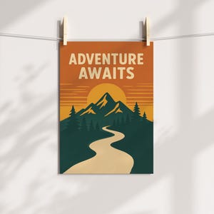 May include: A rectangular poster with the words "ADVENTURE AWAITS" in white block letters. The poster features a mountain range, a setting sun, and a winding road in shades of green, orange, and beige. The poster is hanging from a clothesline with wooden clips.