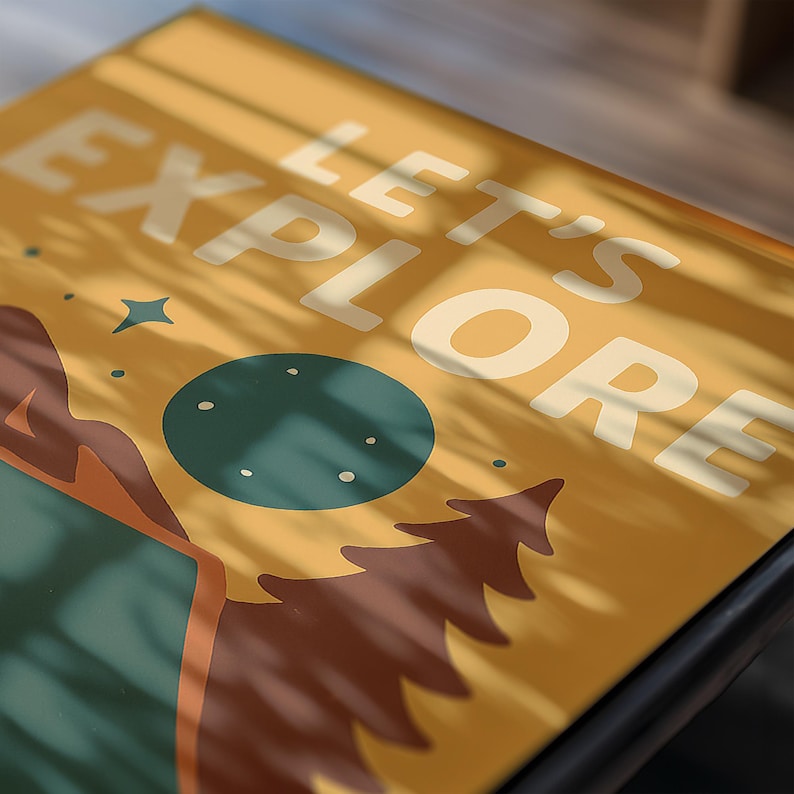 May include: A yellow rectangular surface with the words "LET'S EXPLORE" in white. The design features a teal circle, brown mountains, a green tree, and a blue star. The image is lit with shadows.