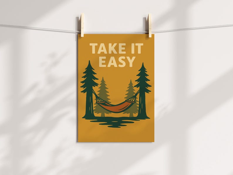May include: A mustard-coloured poster with the words "TAKE IT EASY" in white. The image features a hammock strung between two pine trees, with a forest backdrop. The hammock is orange and brown.
