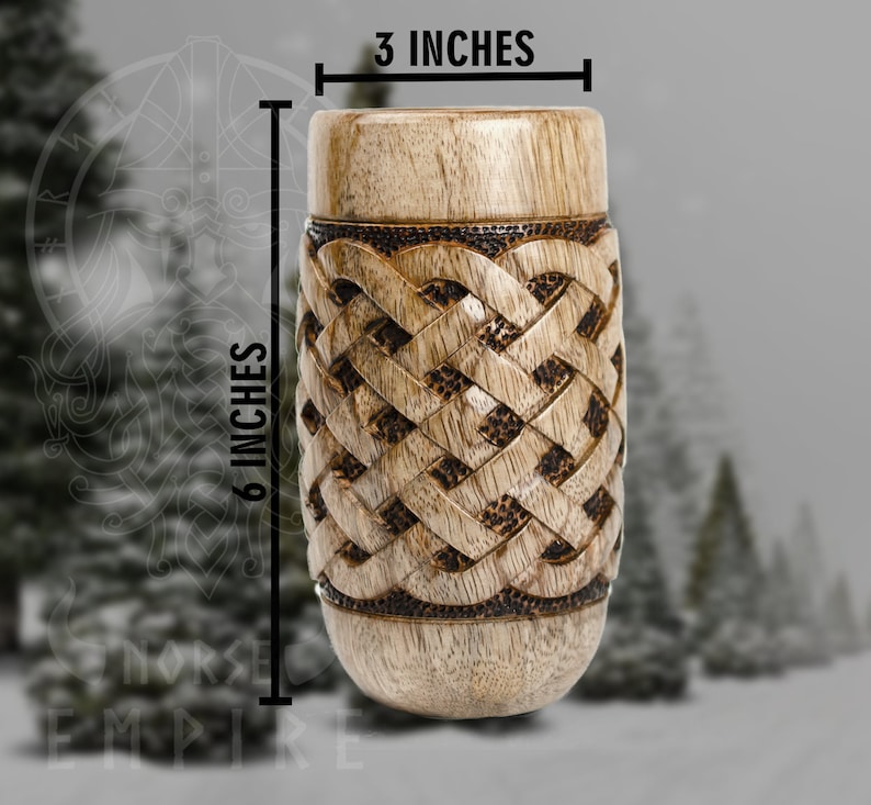 May include: A wooden drinking cup with a Celtic knot design. The cup is 6 inches tall and 3 inches wide.