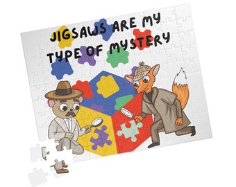 May include: A white jigsaw puzzle with the text "JIGSAWS ARE MY TYPE OF MYSTERY". The puzzle features cartoon illustrations of a bear and a fox detective, each holding a magnifying glass. Colorful puzzle pieces are in the center.