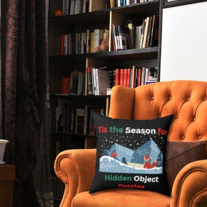 May include: A black throw pillow with a white snowflake design and the text "Tis the Season for Hidden Object Puzzles".