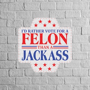 May include: A white sticker with red and blue text that reads "I'd rather vote for a FELON than a JACKASS." The sticker has a unique shape with red stars and a dashed border, set against a gray brick wall.