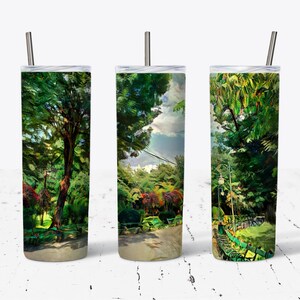 May include: Three stainless steel tumblers with a green, leafy, and colorful nature scene design. The tumblers have lids and straws.
