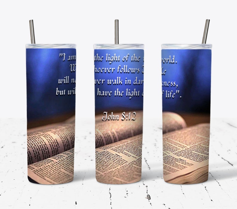 May include: A stainless steel tumbler with a blue background and a bible verse, "I am the light of the world. Whoever follows me will never walk in darkness, but will have the light of life." John 8:12