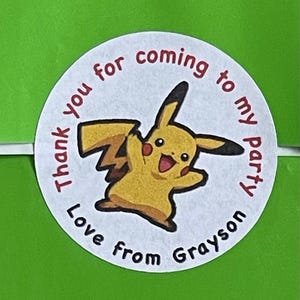 May include: Round white thank you sticker with a yellow Pikachu cartoon character. The sticker says "Thank you for coming to my party Love from Grayson".