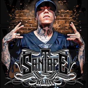May include: A black and white graphic design with the text "The San Rafael Klan Designs" in a stylized font. The design features a person with tattoos wearing a black jersey with a white cross on the chest and a black baseball cap. The background is a brick wall with a black and white splatter effect.