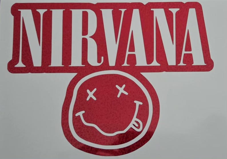 Puede incluir: Una calcoman&iacute;a de vinilo hologr&aacute;fico rojo que presenta la palabra NIRVANA en letras may&uacute;sculas blancas en negrita sobre un gr&aacute;fico de cara sonriente cl&aacute;sica con ojos en forma de X y una lengua afuera, todo sobre un fondo rojo s&oacute;lido.