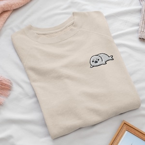 Süßes Harp Robb besticktes Rundhals-Sweatshirt: Baumwollmischung, Unisex-Passform
