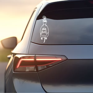 May include: White vinyl decal of a cartoon cat and bird on a gray car. The cat is sitting with its legs dangling and the bird is perched on its back.