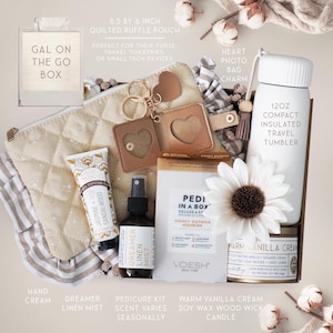 May include: A gift set featuring a quilted ruffle pouch, a heart photo bag charm, and a 12oz insulated travel tumbler. Includes hand cream, Dreamer linen mist, a pedicure kit, and a warm vanilla cream soy wax wood wick candle. The pouch is 8.5 by 6 inches.