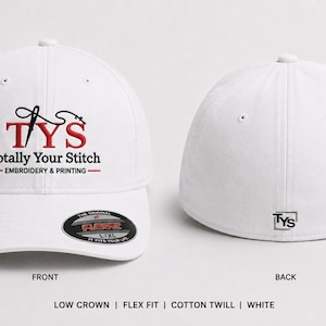 May include: A white low crown cotton twill baseball cap with a Flexfit band. The front features a black needle icon, red TYS letters, and the text Totally Your Stitch Embroidery & Printing. The back displays a small black TYS logo in a square.