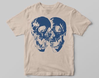 May include: A beige t-shirt with a blue graphic of two skulls facing each other.
