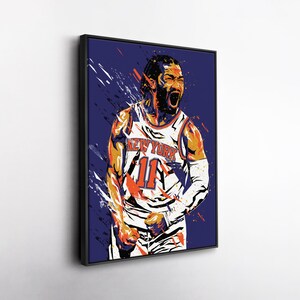 May include: A framed art print of a basketball player in a New York Knicks jersey, number 11. The artwork features a vibrant, stylized design with orange, white, and blue colors against a dark blue background. The player is depicted with an open mouth.